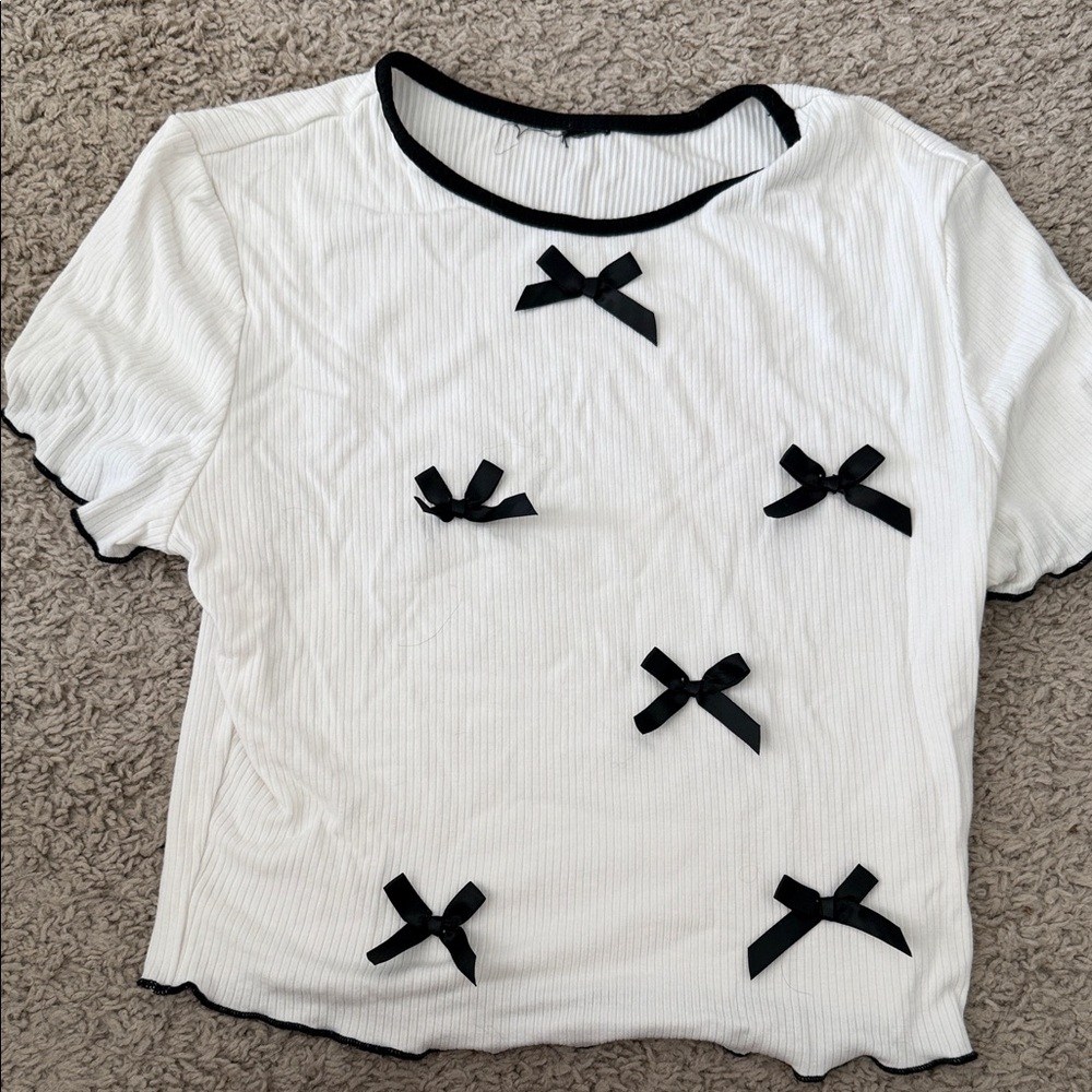 Chic White Top with Black Bow Accents
